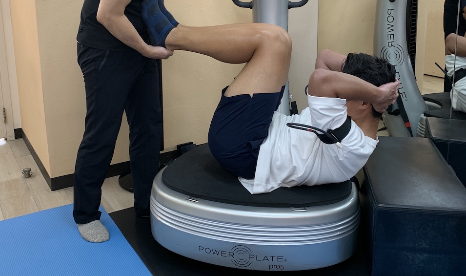 加圧トレーニングで腹筋運動する男性